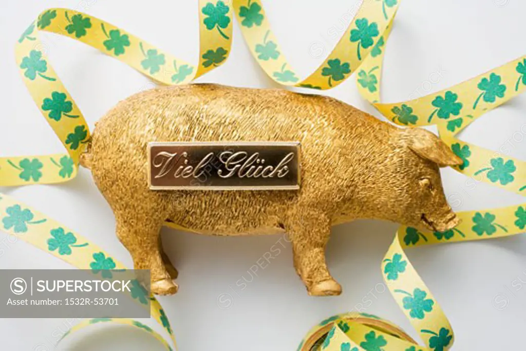 Golden pig with bow for New Year (good luck charm)