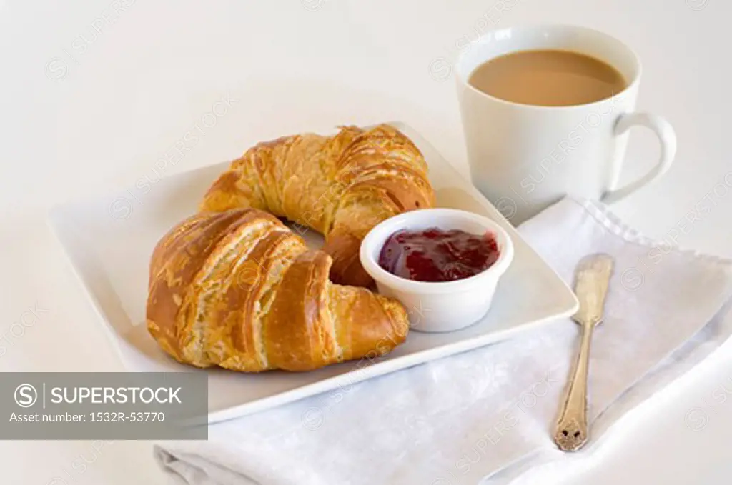 Croissants with Jelly on a Plate; Cup of Coffee