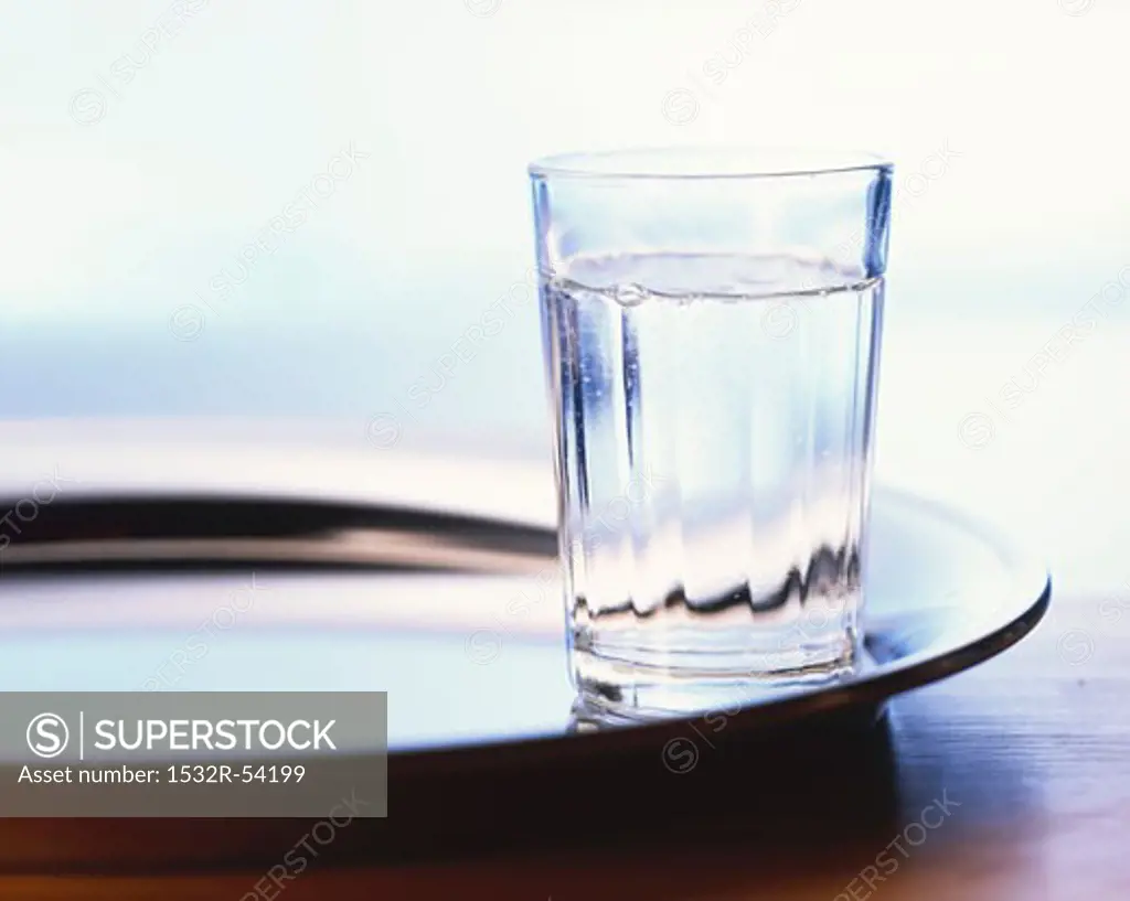 A glass of water on a tray