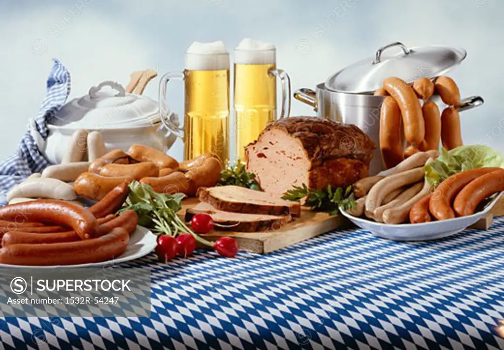 Bavarian sausages with beer on tablecloth