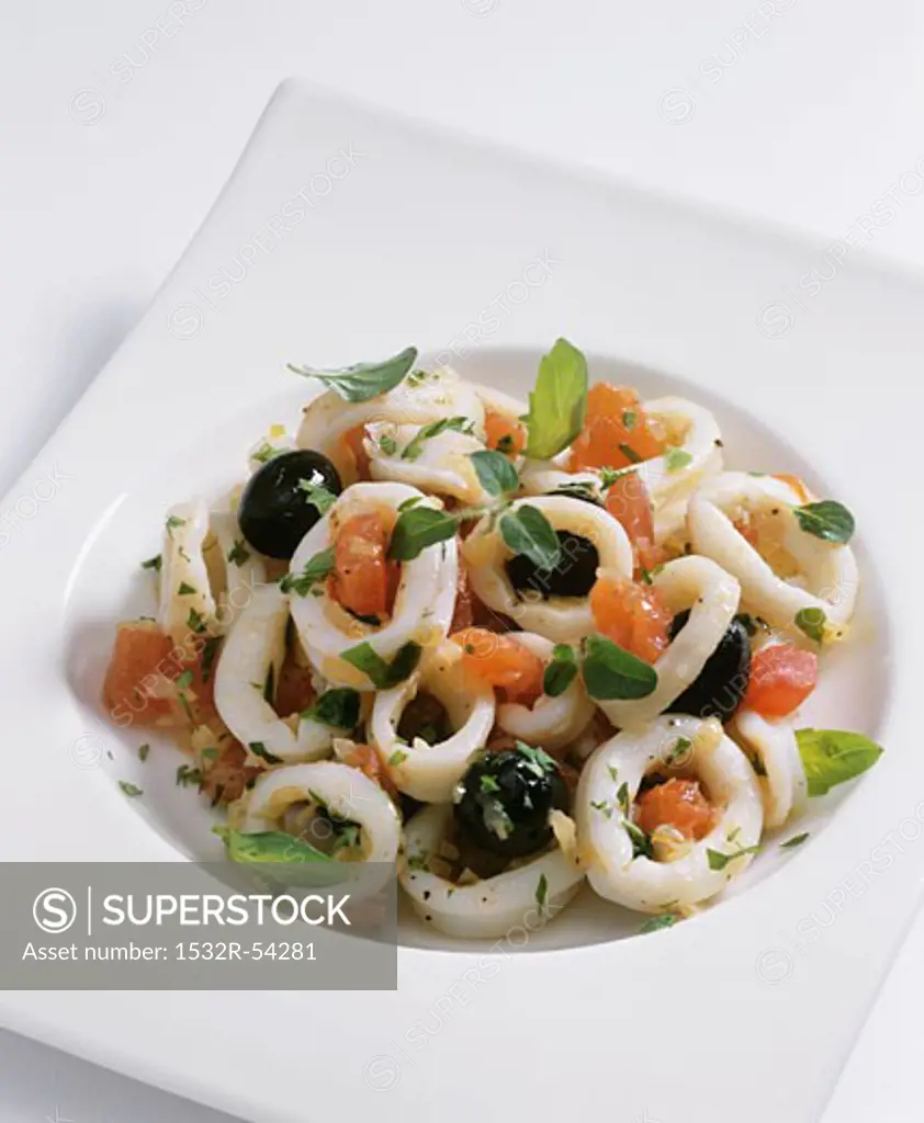 Squid salad with olives, tomatoes and herbs