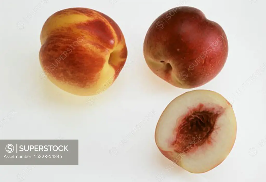 Two whole nectarines and half of a nectarine