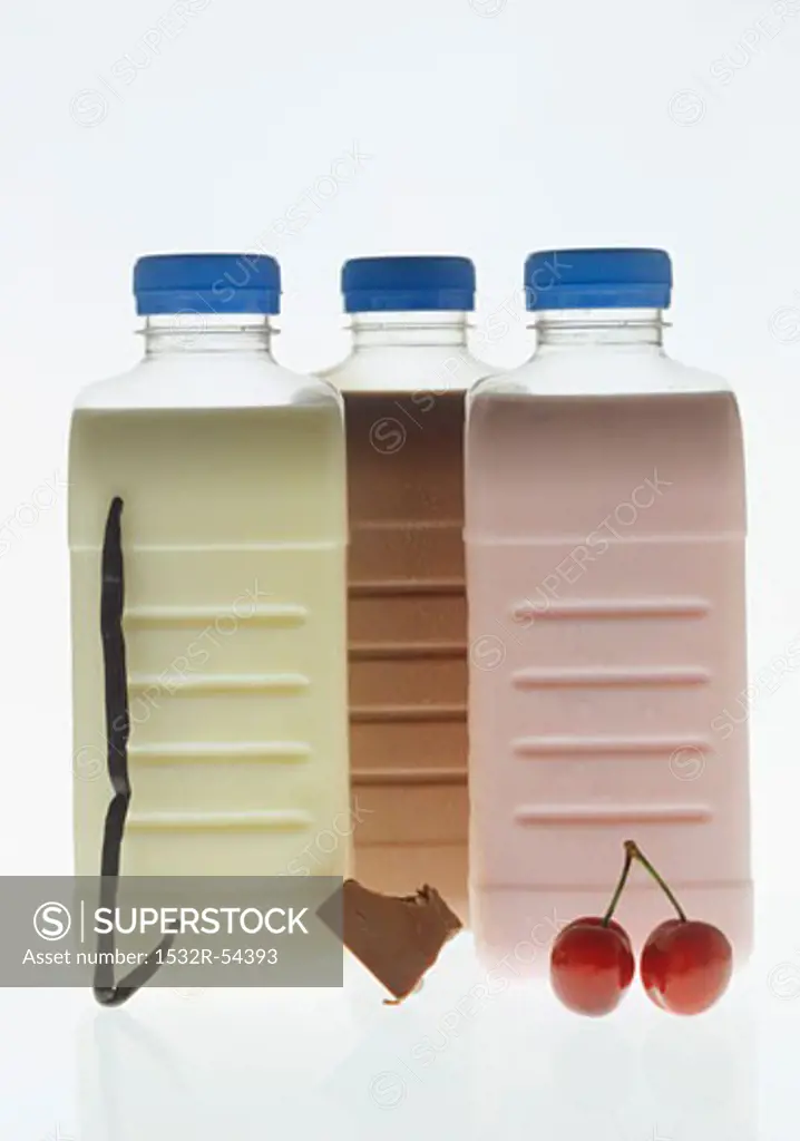 Vanilla, chocolate and cherry milk in plastic bottles