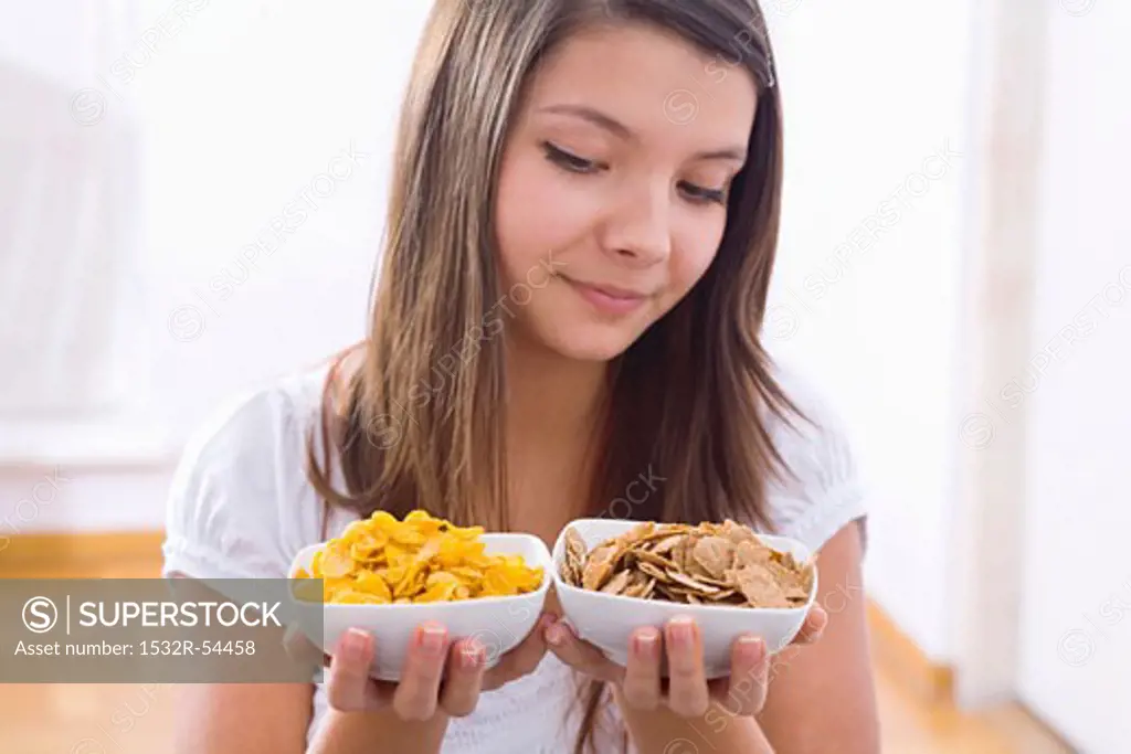 Girl holding two bowls of cornflakes