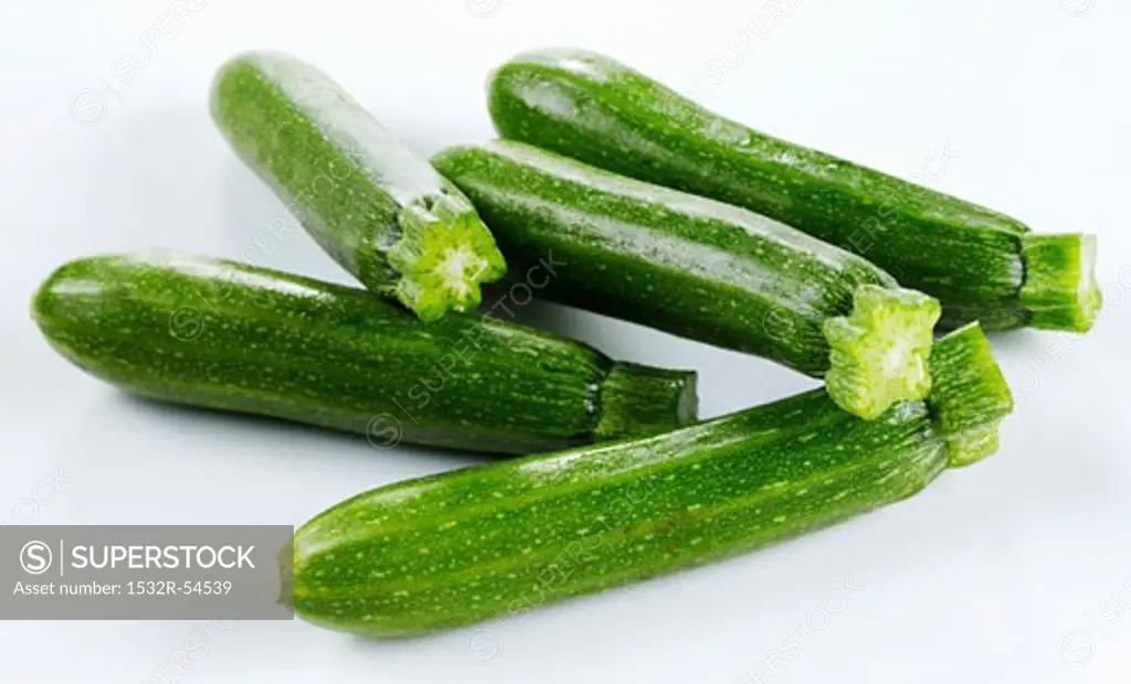 Courgettes on white surface