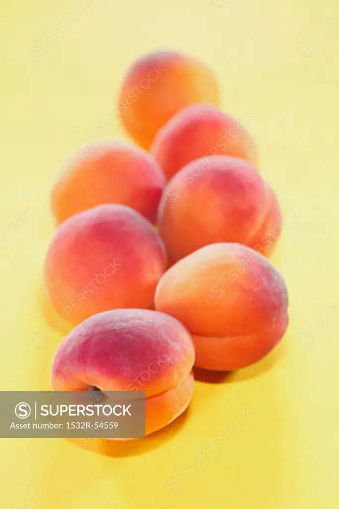 Several apricots on yellow background