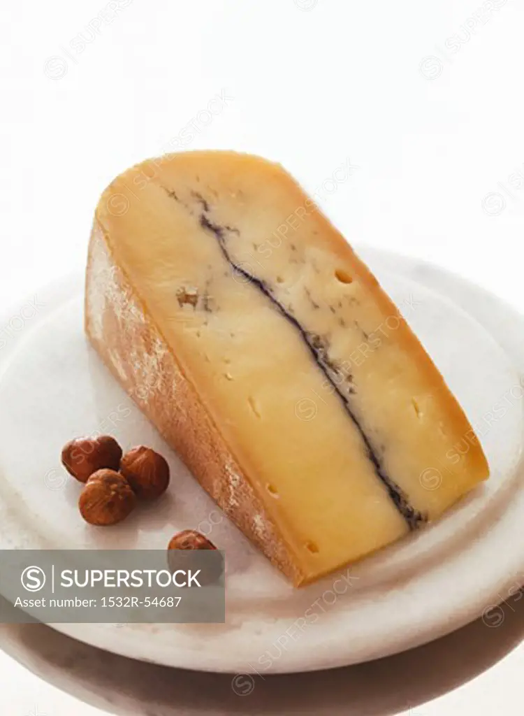 Wedge of Blue Cheese with Nuts on a Plate