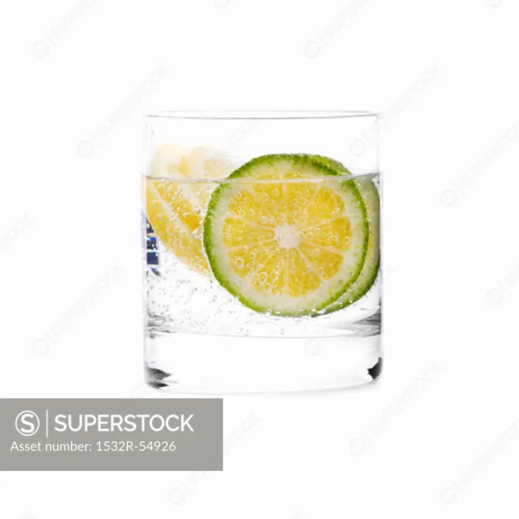 A glass of water with slices of lime