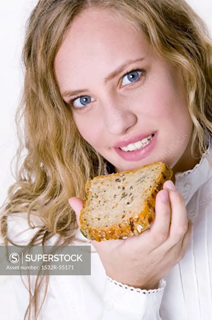 Woman holding a slice of grannary bread