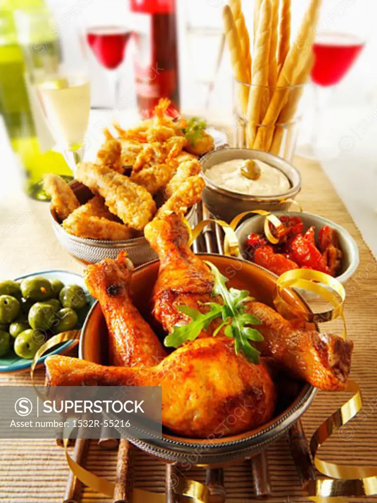 Party buffet with chicken drumsticks