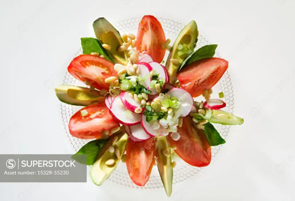 Tomato and avocado salad with radishes and pine nuts
