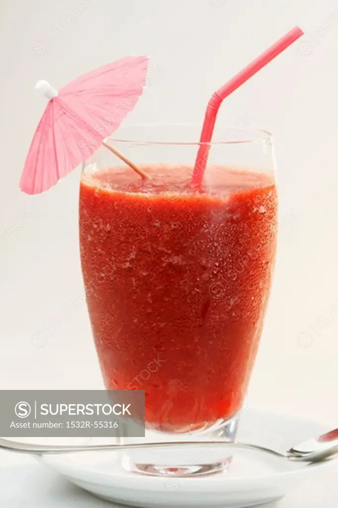 A frozen strawberry daiquiri with a cocktail umbrella