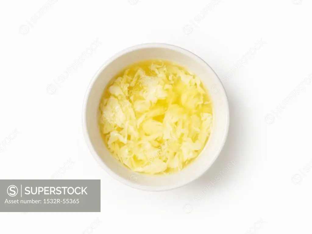 A bowl of egg soup, seen from above