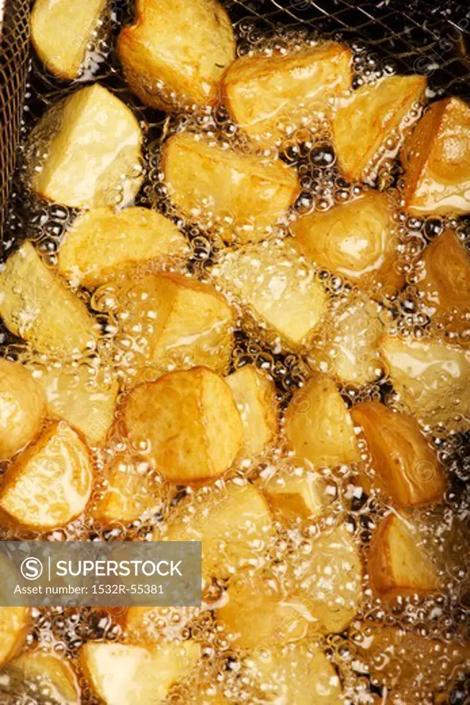 Potatoes being fried in hot oil
