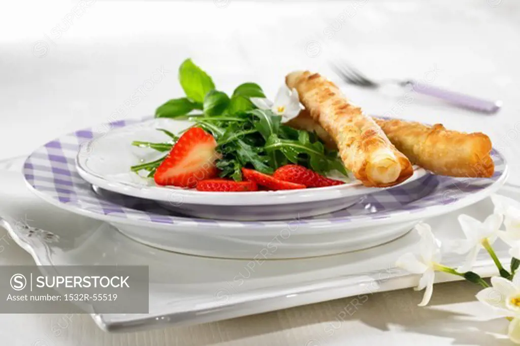 Asparagus wrapped in puff pastry with raspberries and rocket