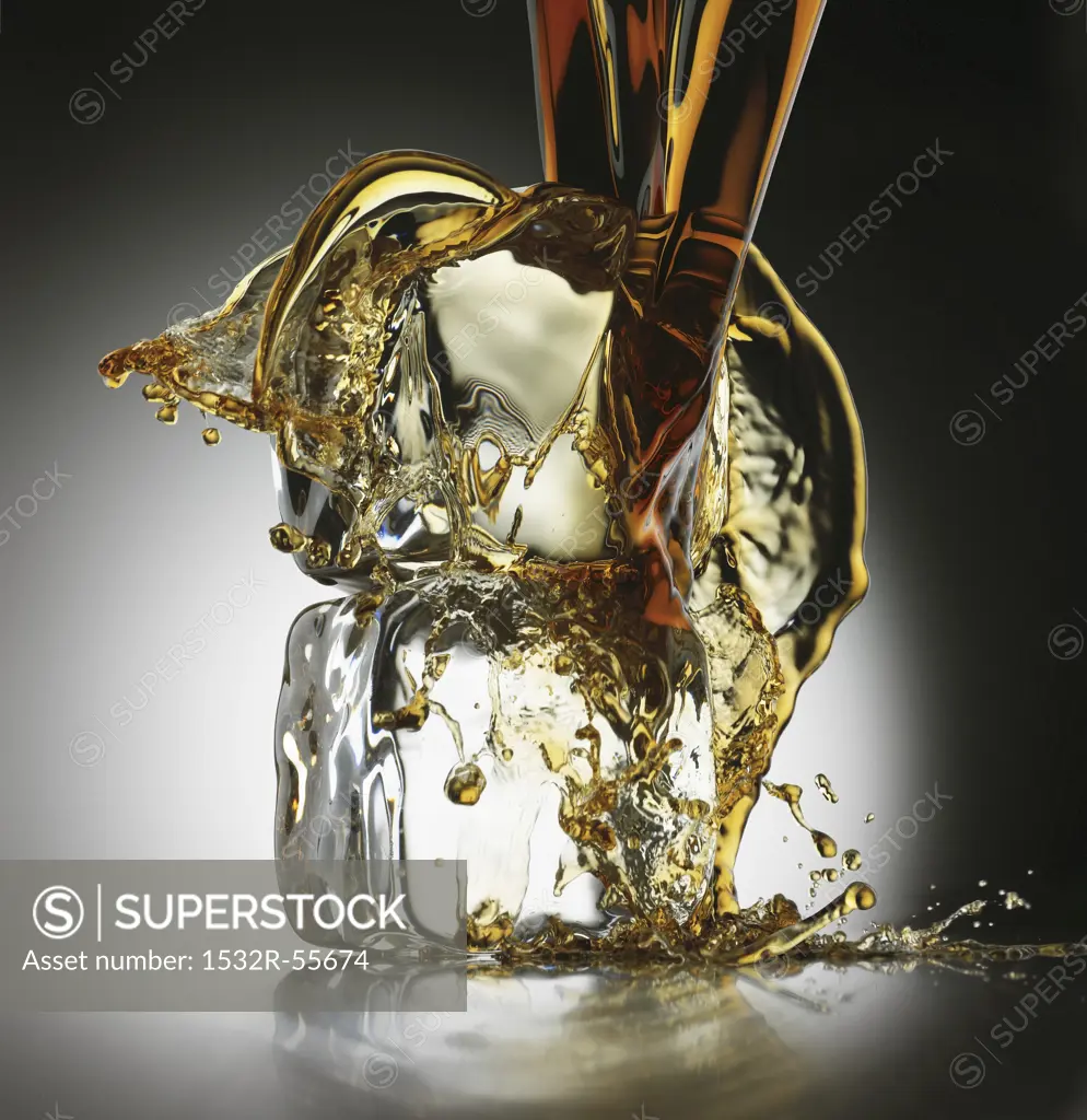 Cola being poured over ice cubes