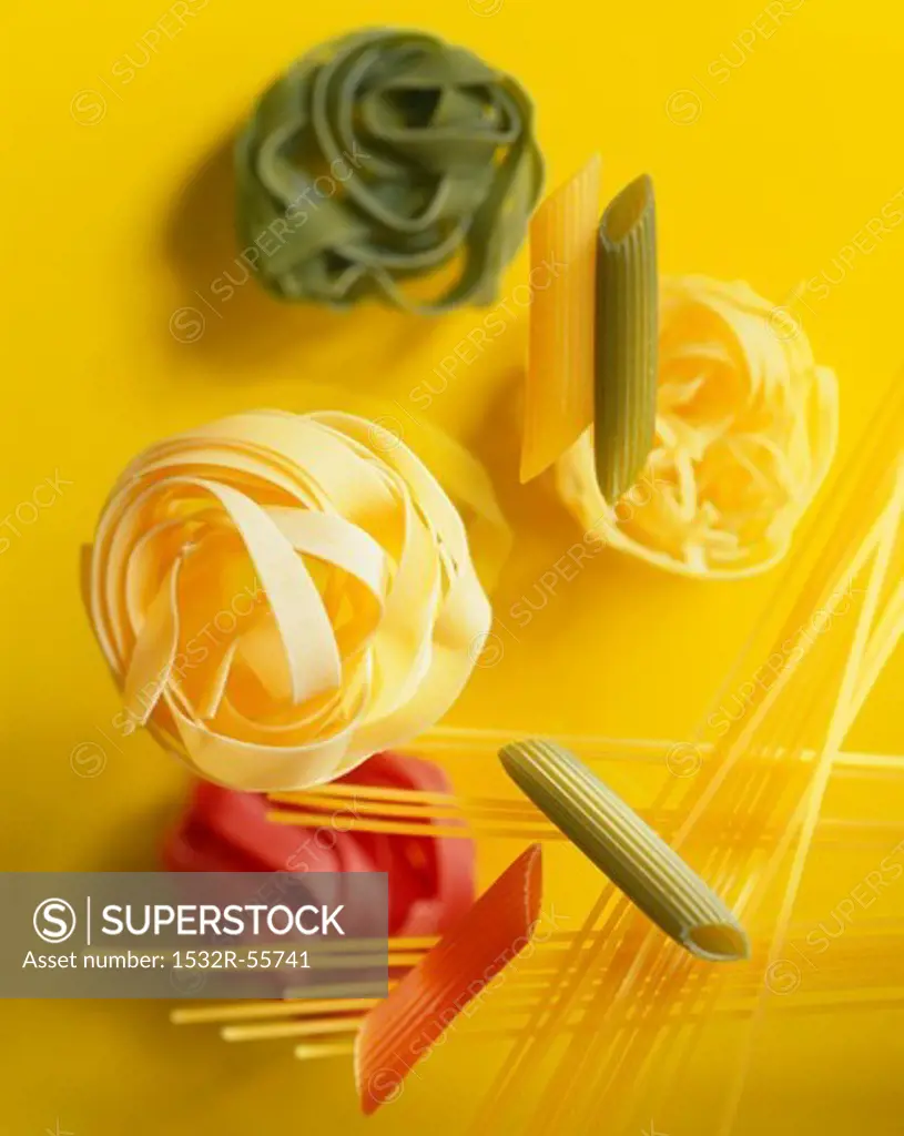 Various types of pasta on a yellow background