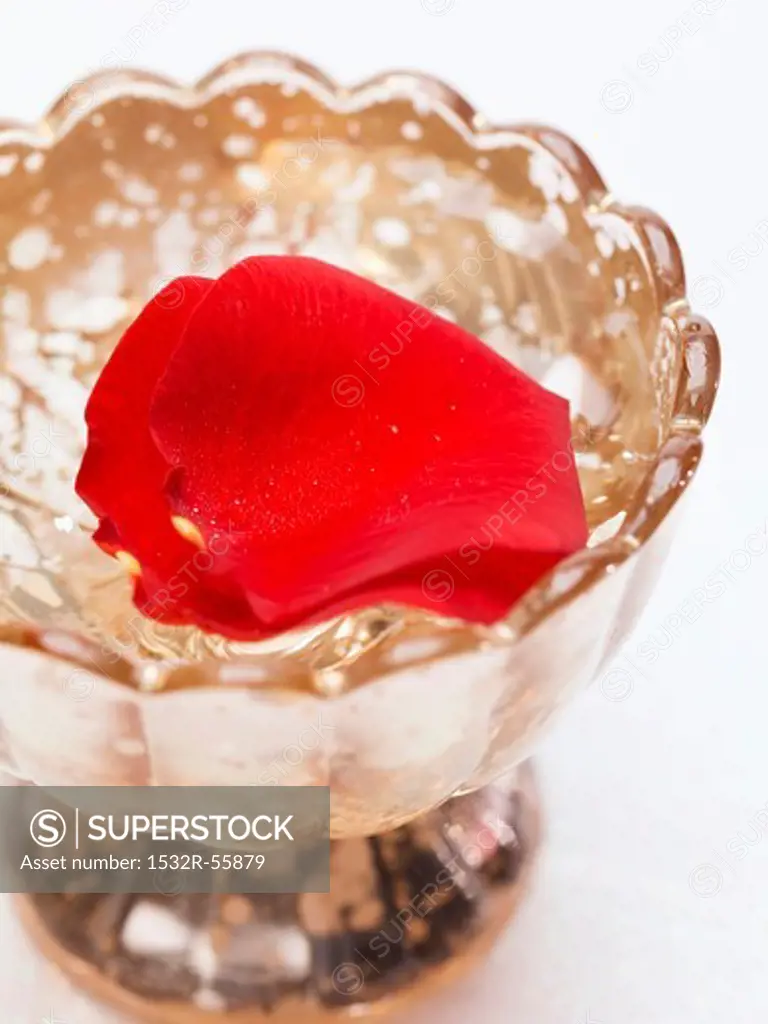 Red rose petals in silver dish