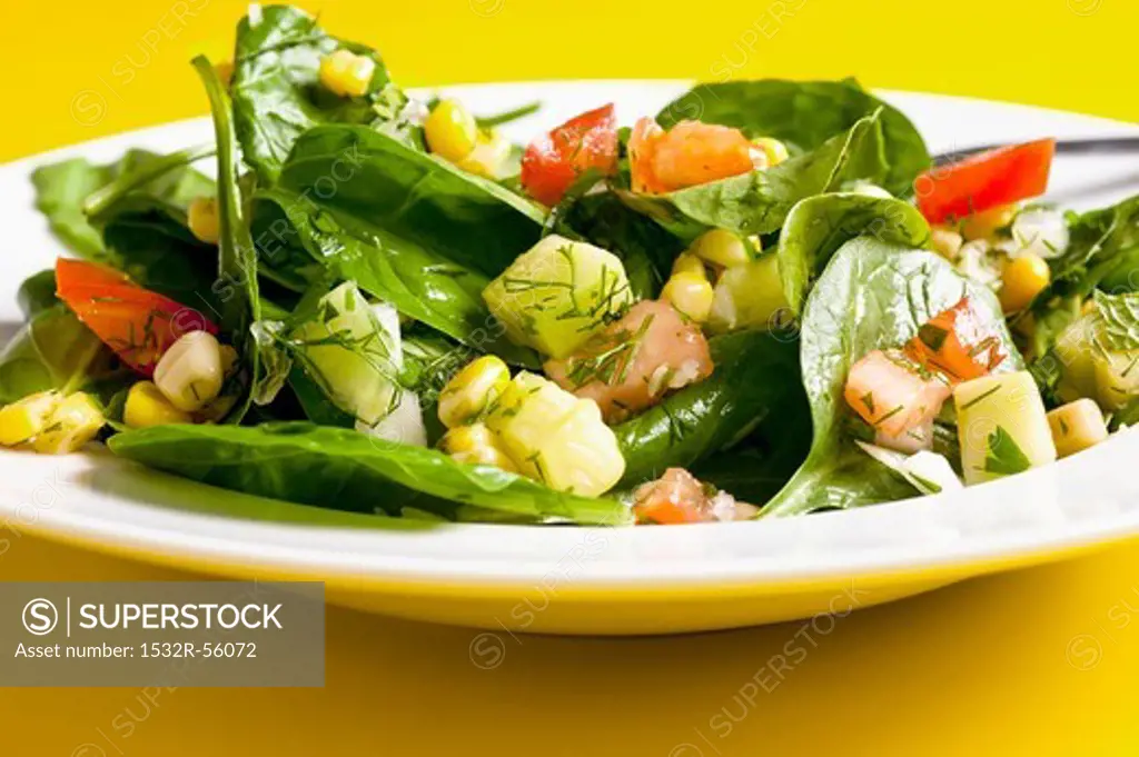 Spinach and sweetcorn salad with tomatoes, cucumber and dill