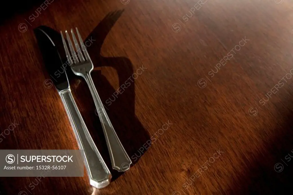 Silver Fork and Knife on an Oak Table