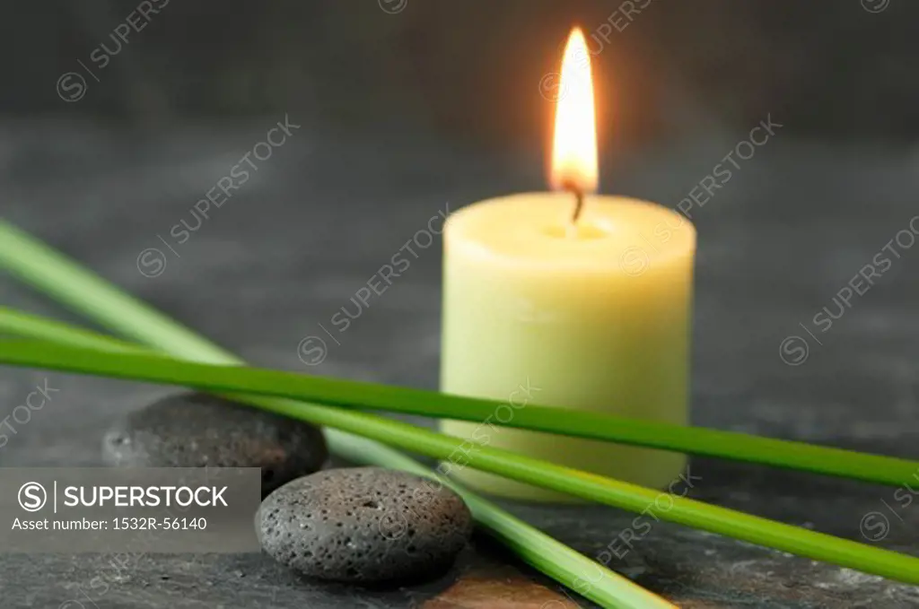 A candle, pebbles and papryus sedge