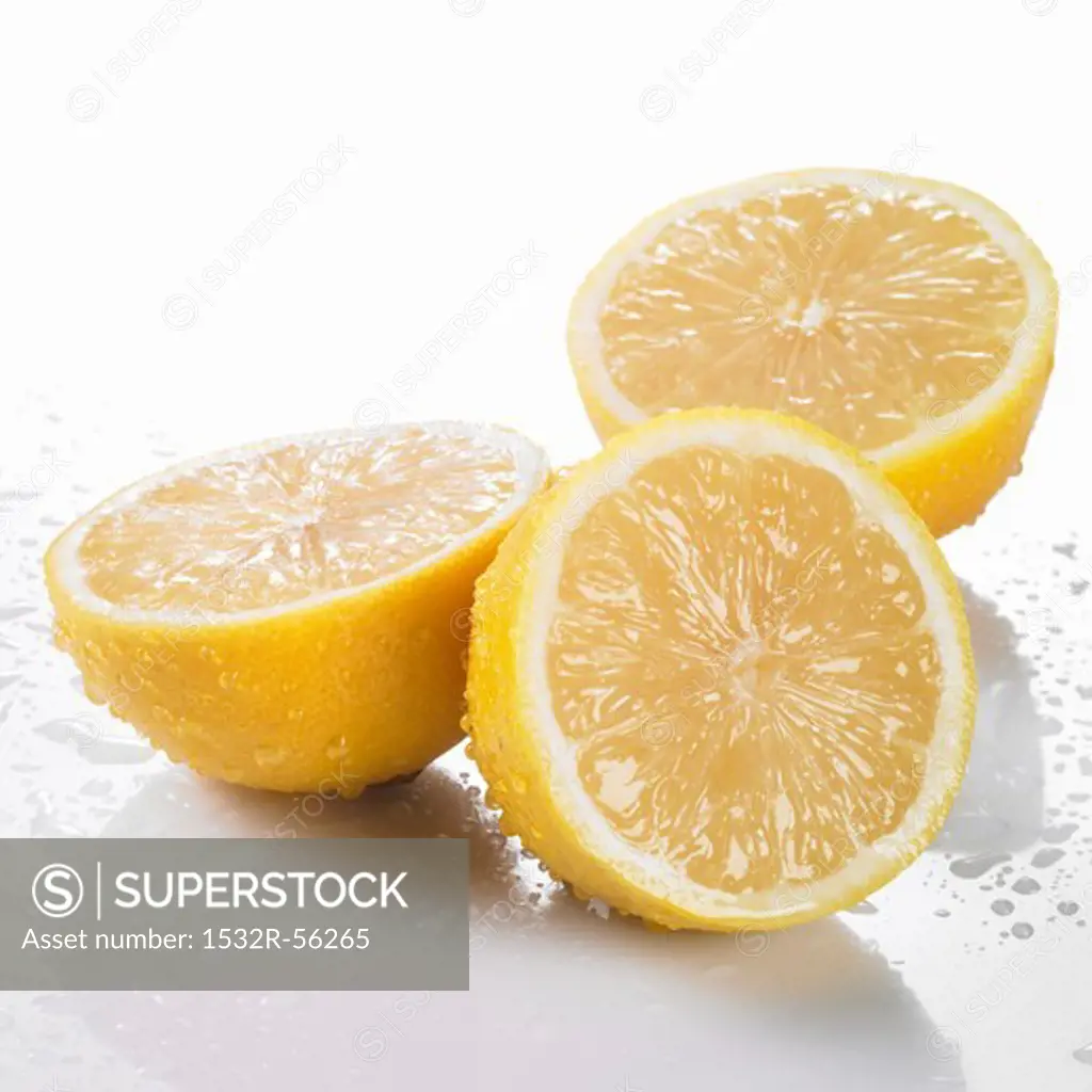 Three freshly washed lemon halves
