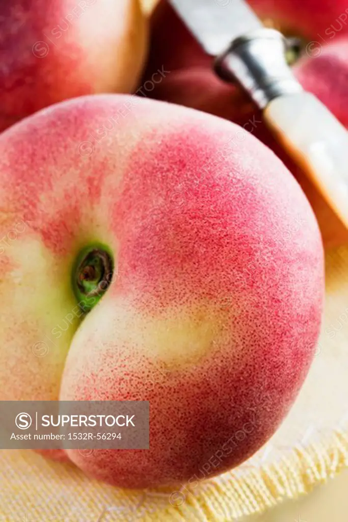 A peach and a knife (close up)