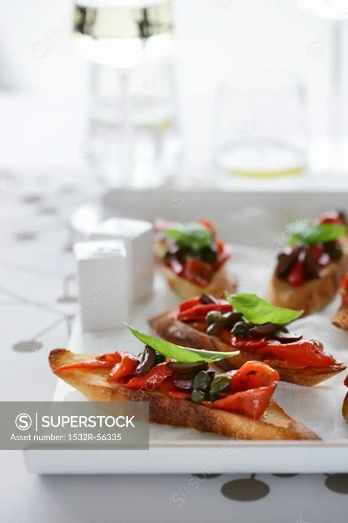 Bruschetta with pepper, capers and basil