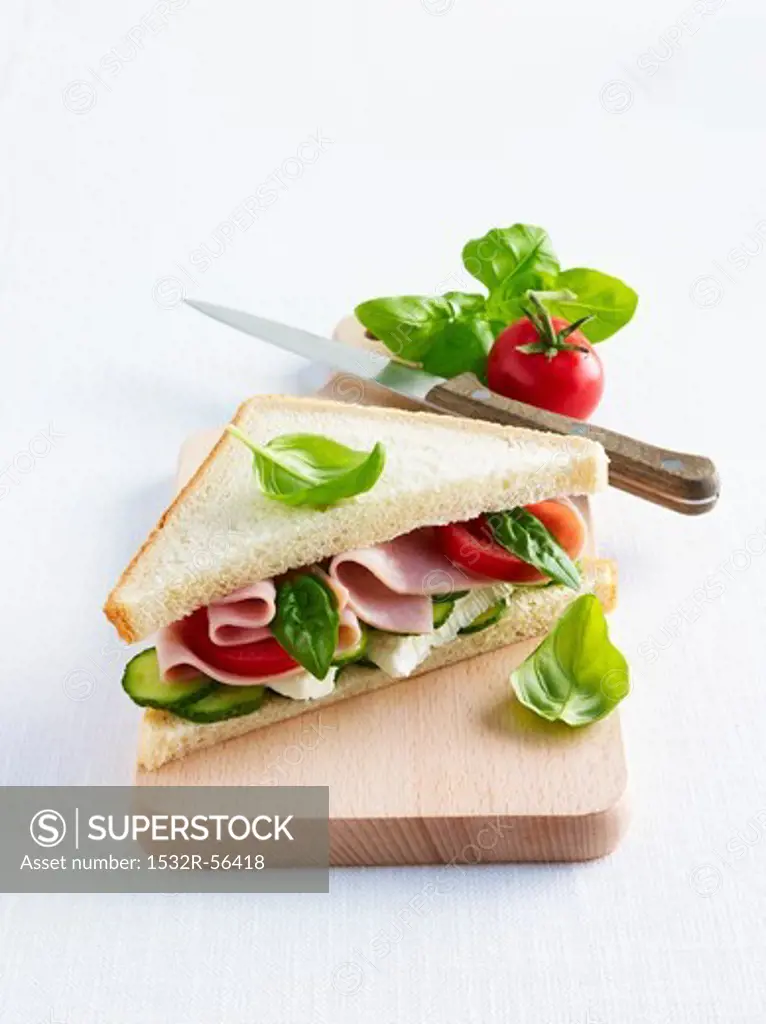 A ham, Camembert, tomato, cucumber and basil sandwich