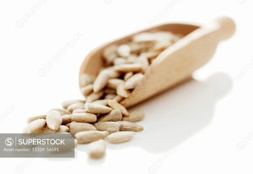 Sunflower seeds in a wooden scoop