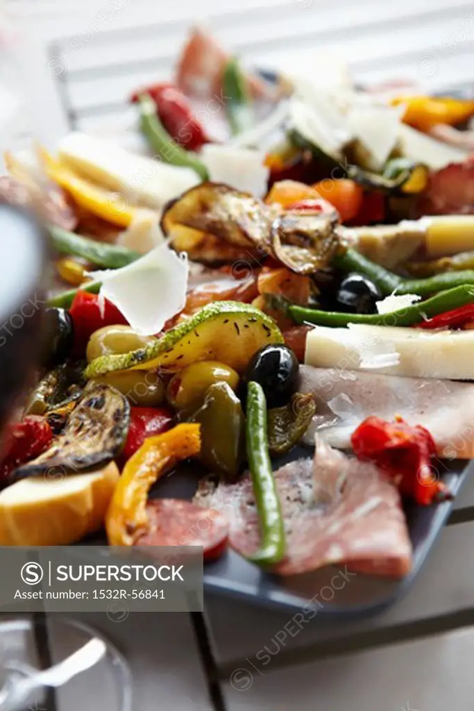 Antipasti platter with sausage, cheese and vegetables