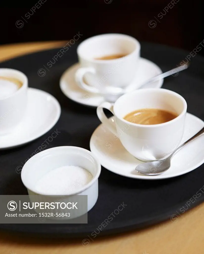 Espresso cups and a sugar bowl on a tray