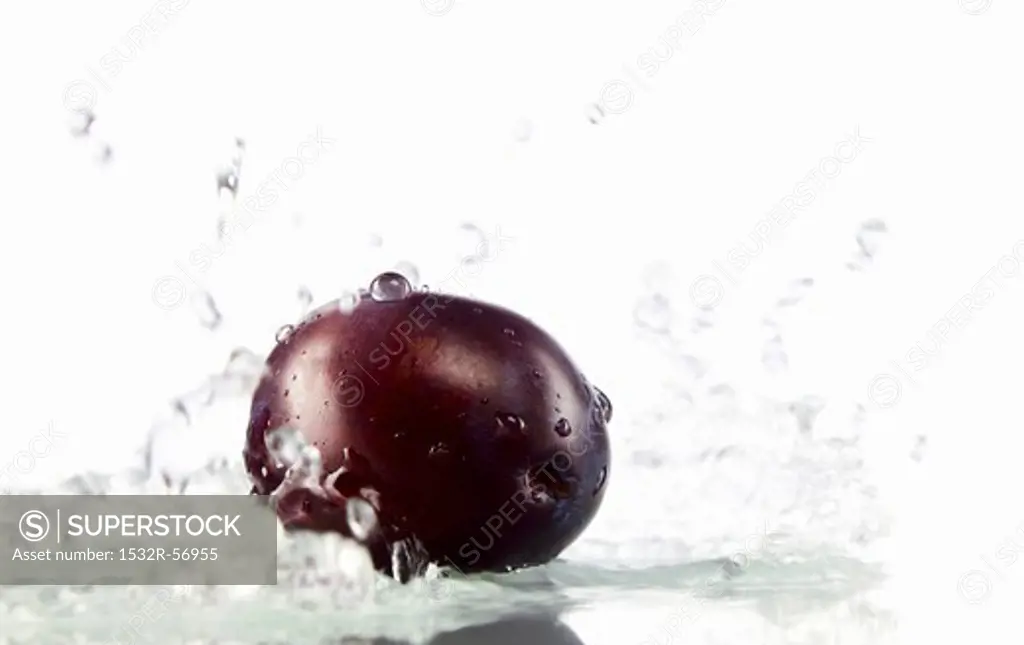 A plum being washed