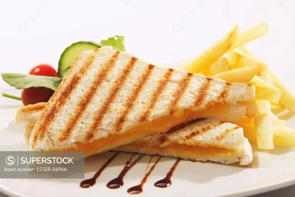 Toasted cheese sandwich with chips, balsamic vinegar and a salad garnish