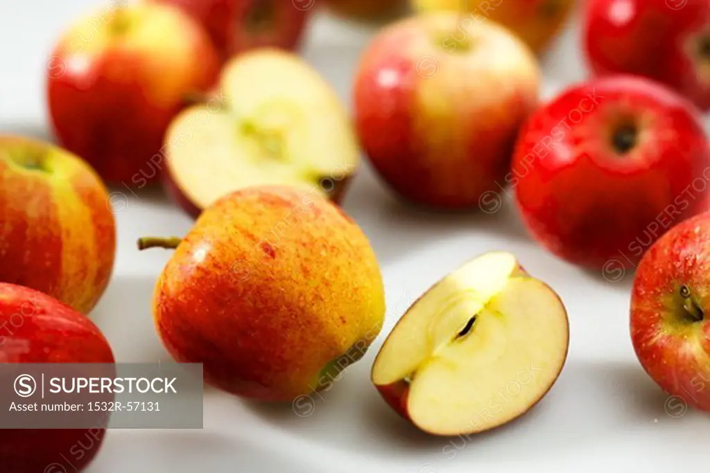 Red apples, whole, halved and sliced