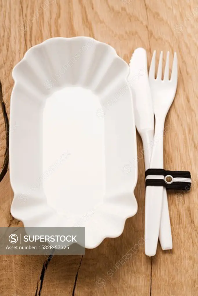 A plastic dish and plastic cutlery
