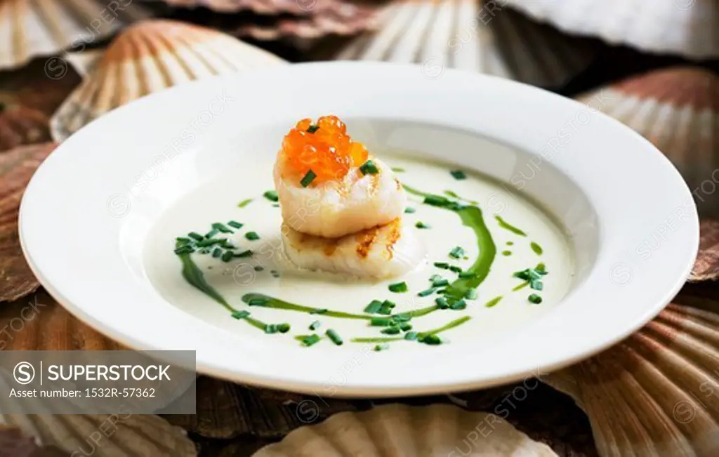 Scallop soup with salmon caviar and rocket