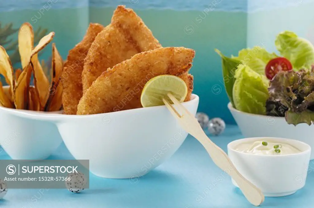 Fish and chips with a mayonnaise dip and a side salad
