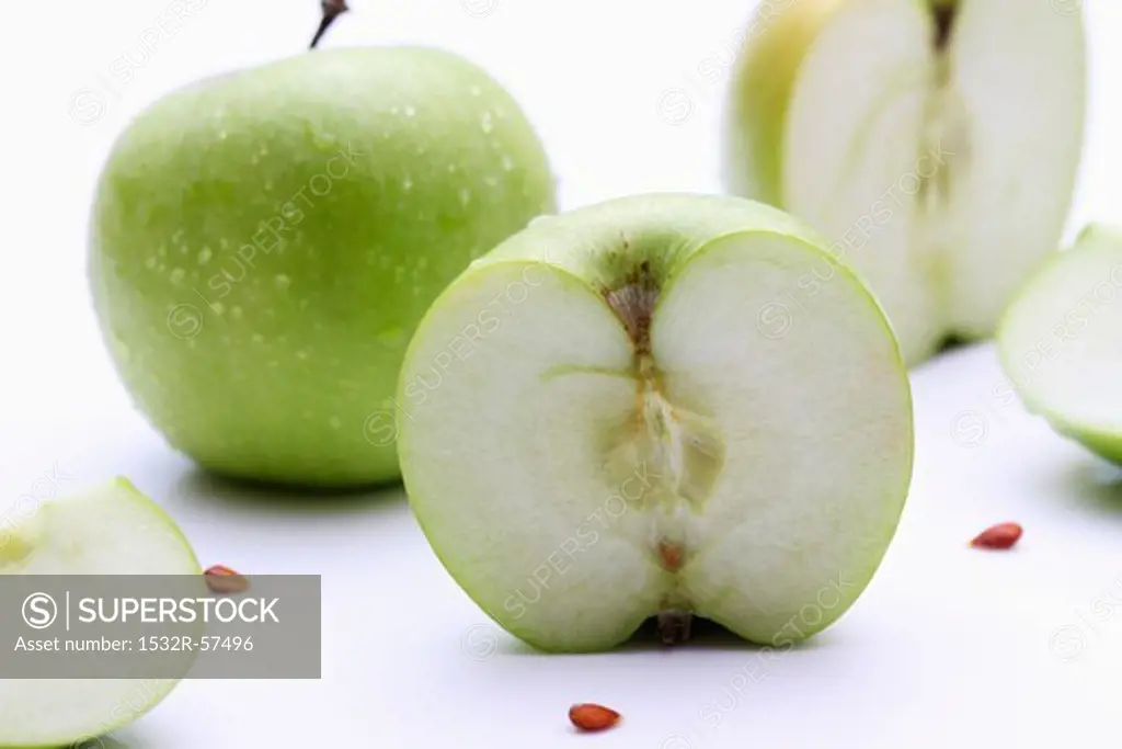 Granny Smith apples, whole and halved