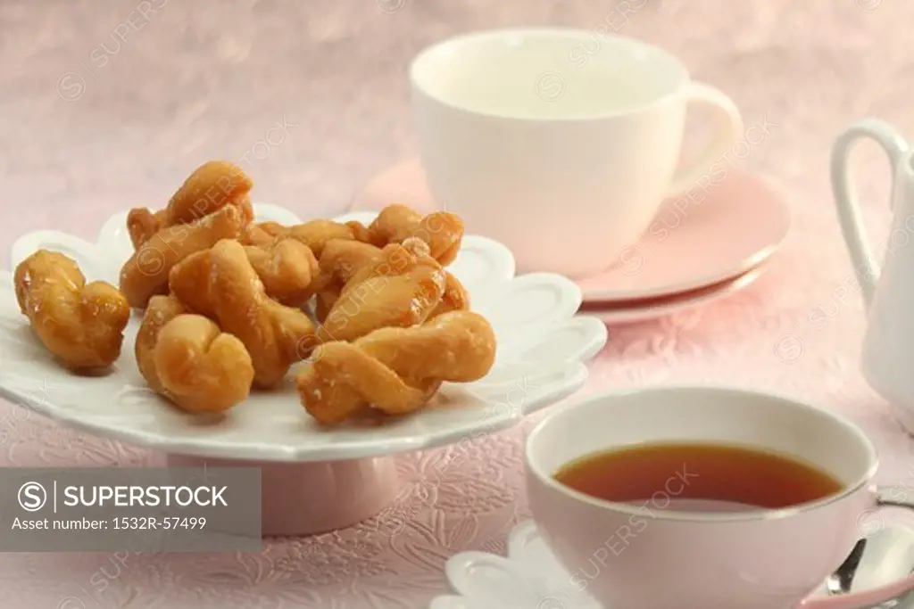 Koeksisters (South African fried dough plaits) with tea