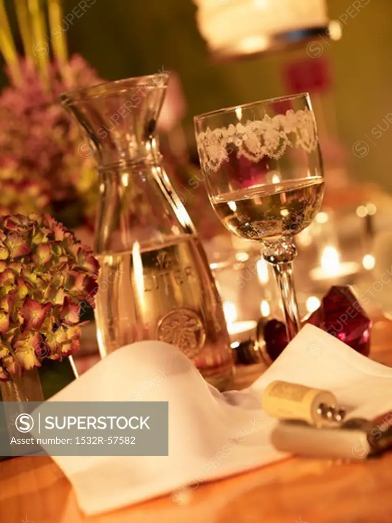 A festively decorated table with white wine