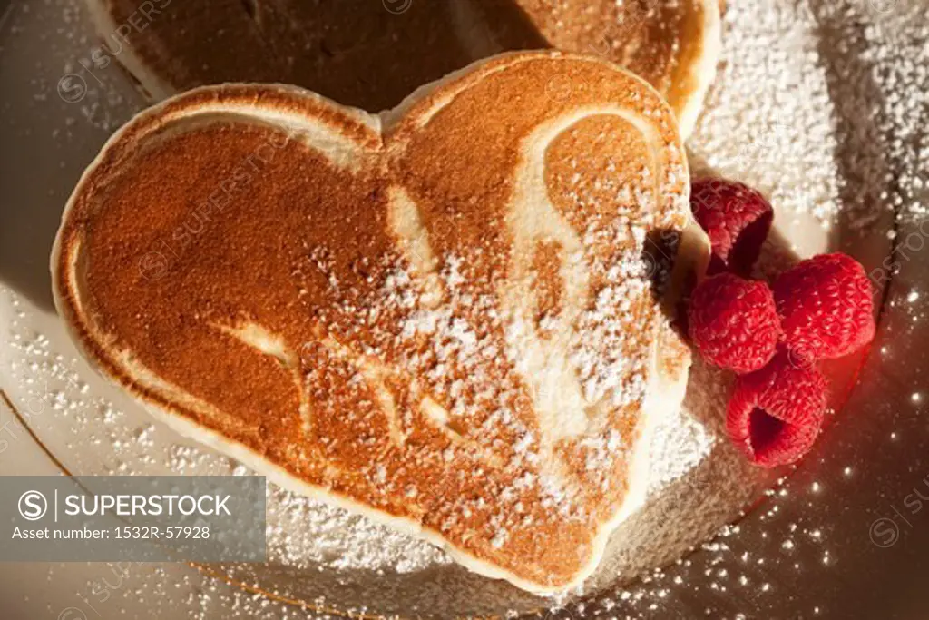 Heart Shaped Pancakes with Raspberries and Powdered Sugar