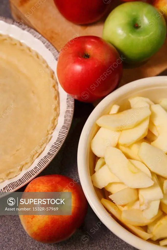 Whole and Sliced Apples with Pie Crust for Baking