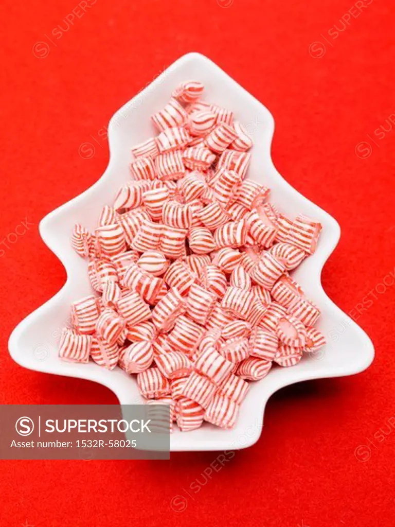 Red and white striped peppermints in dish