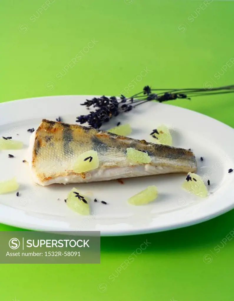 Fried zander with lavender flowers and lime segments