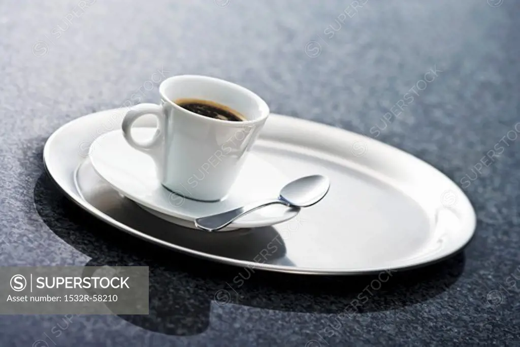 Cup of espresso on stainless steel tray