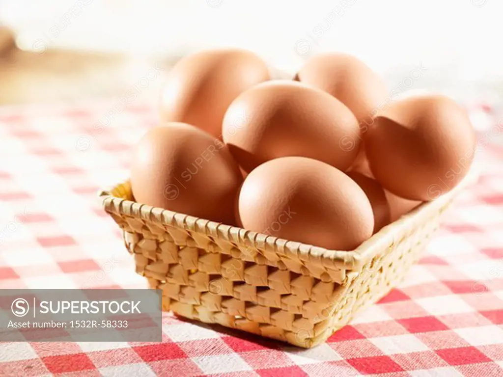 Brown eggs in a small basket