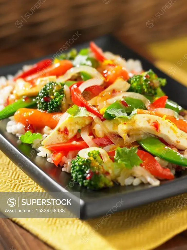 Stir-fried vegetables with tofu on a bed of rice