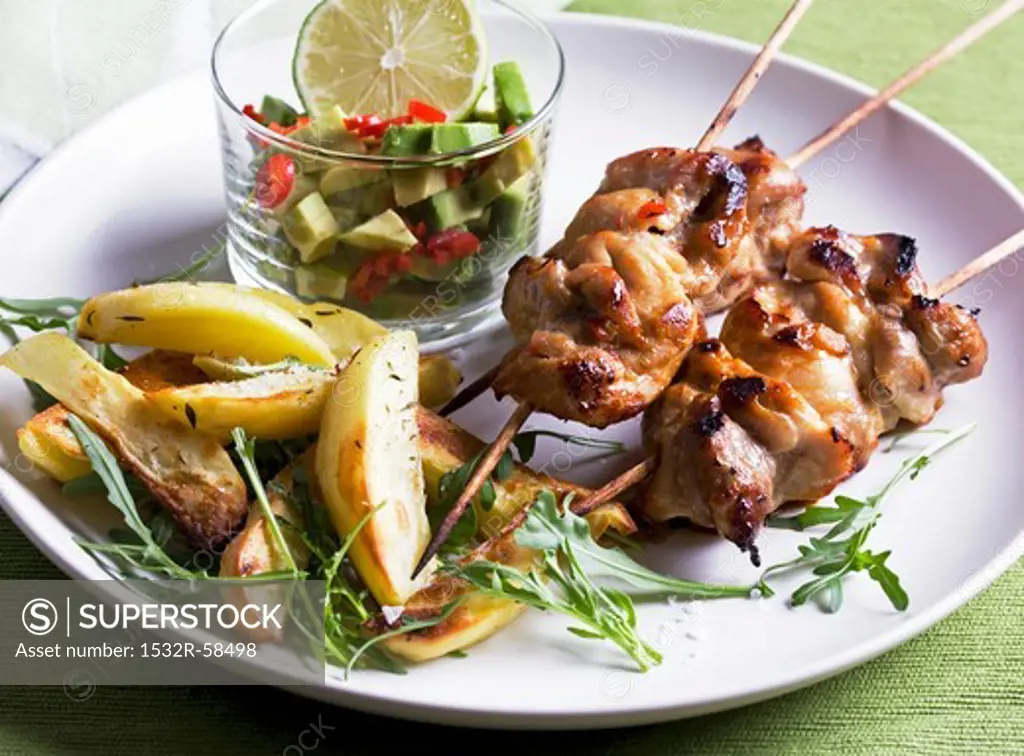 Chicken kebabs with avocado salsa, potatoes and rocket