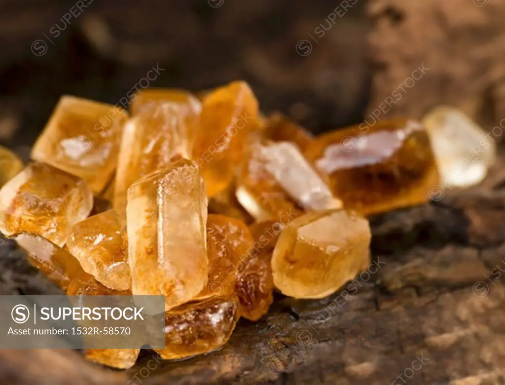 Brown candided sugar on a wooden surface